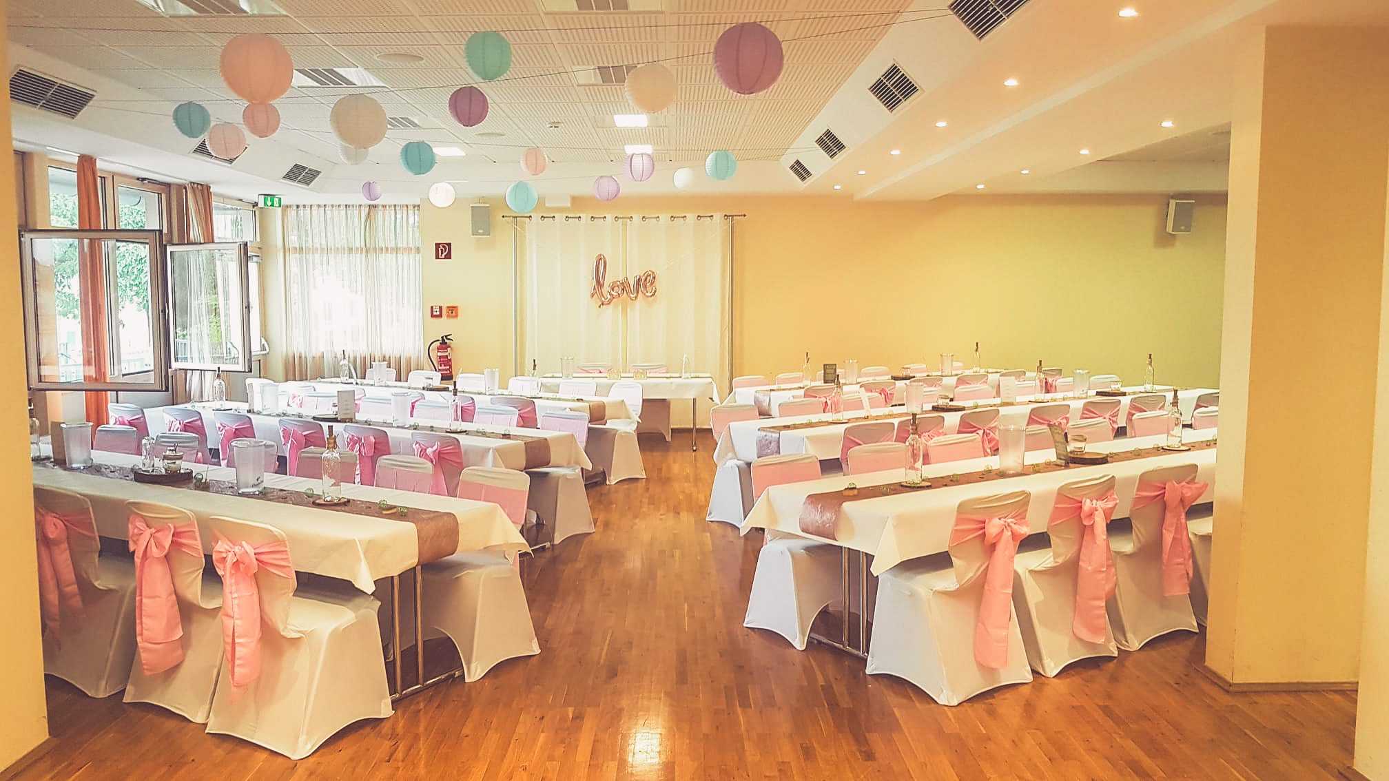 Weiße Stuhlhussen im Bürgerhaus Lang-Göns bei einer Feier – elegante Dekoration für Hochzeiten und besondere Veranstaltungen