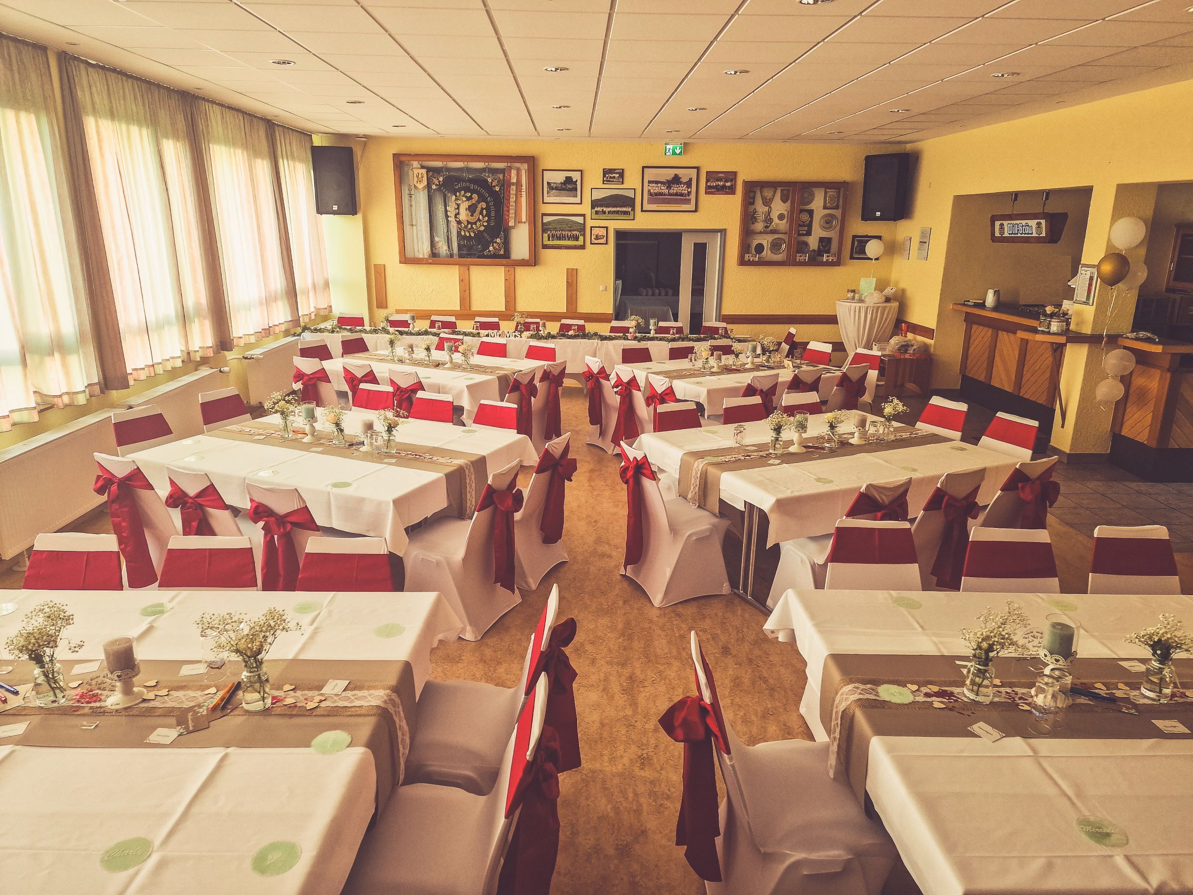 Weiße Stuhlhussen im Dorfgemeinschaftshaus Breitenborn in Biebergemünd bei einer Feier – elegante Dekoration für Hochzeiten und besondere Veranstaltungen