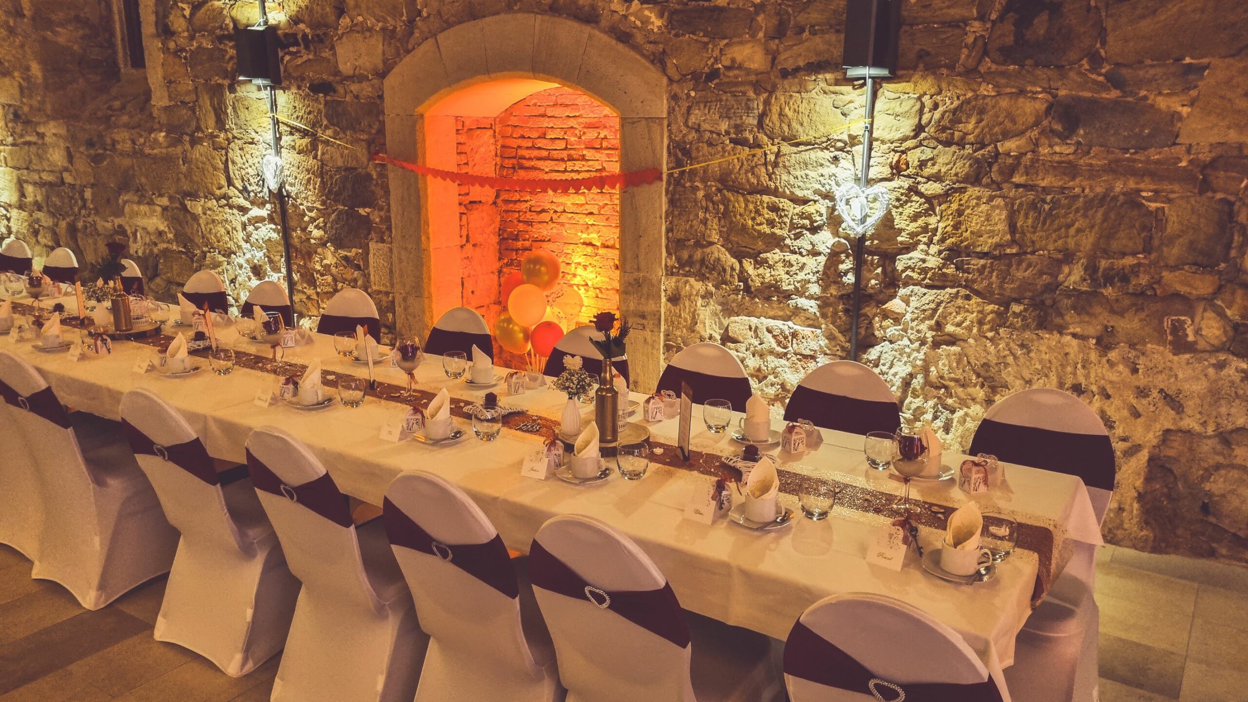 Weiße Stuhlhussen im Schloss Eyrichshof in Ebern bei einer Feier – elegante Dekoration für Hochzeiten und besondere Veranstaltungen