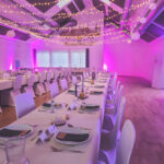 Weiße Stuhlhussen im Dorfgemeinschaftshaus Nieder-Ohmen in Mücke bei einer Feier – elegante Dekoration für Hochzeiten und besondere Veranstaltungen