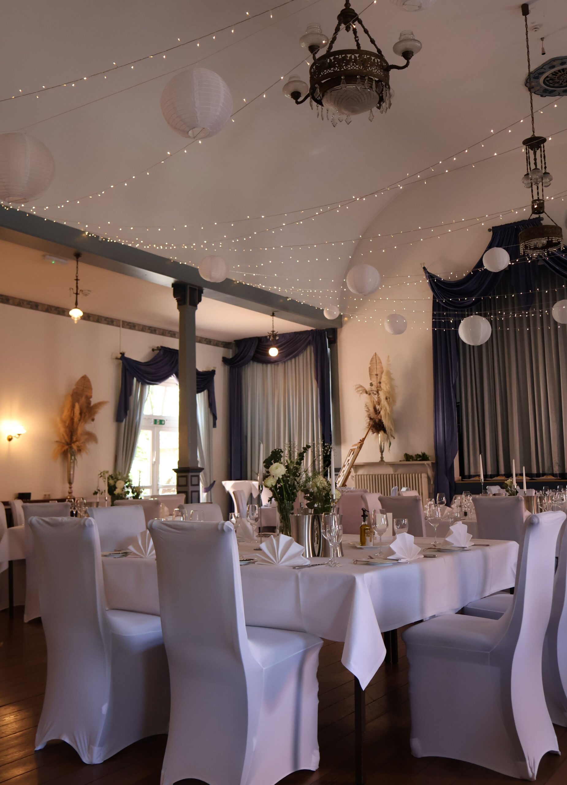 Stuhlhussen Hotel Altes Land Jork Weiße Stuhlhussen im Hotel Altes Land in Jork bei einer Feier – stilvolle Dekoration für Hochzeiten und besondere Anlässe